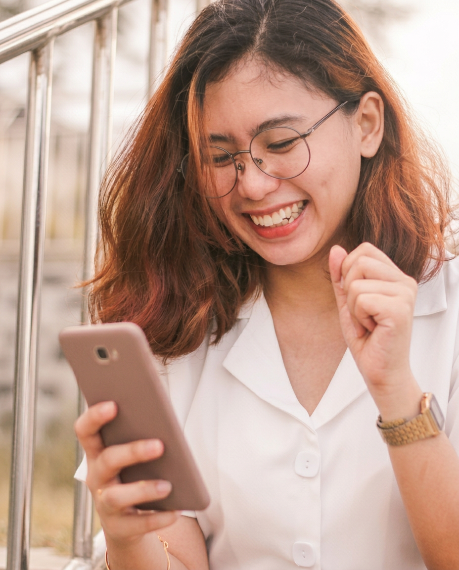 Woman smiling while using her phone